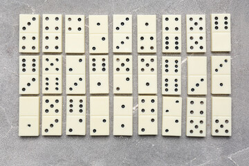 Many white dominos blocks on grey grunge background