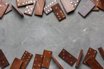 Frame made of wooden dominos blocks on grey grunge background