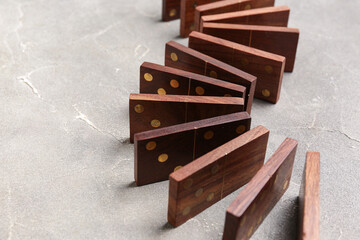 Wooden dominos blocks in shape of zigzag on grey grunge background