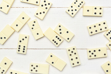 Many dominos blocks on white wooden background