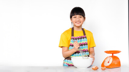A cheerful little girl is smiling brightly while mixing ingredients to make a cake.. isolated white background.