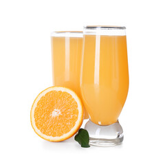 Glasses of tasty juice with orange and leaf on white background