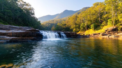 Serene Waterfall Flowing Through Lush Green Wilderness Landscape