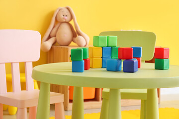 Colorful cubes on table in children's room, closeup