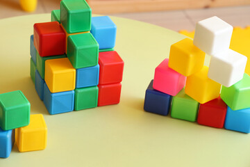 Obraz premium Colorful cubes on table in children's room, closeup