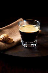 Coffee in glass cup on dark background. Close up. Copy space