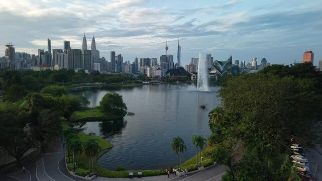 aerial view of kuala lumpur in the background with beautiful morning lark park scenery people jog