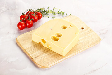 Maasdam cheese brick over board