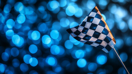 Checkered flag waving against a blue bokeh background at a motorsport event. 