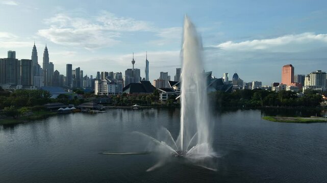 aerial view of kuala lumpur in the background with beautiful morning lark park scenery people jog