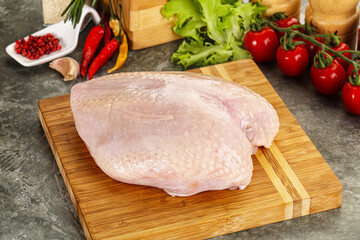 Raw chicken breast with skin