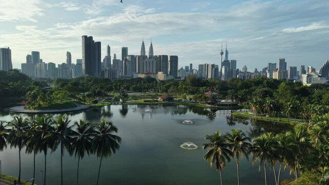 aerial view of kuala lumpur in the background with beautiful morning lark park scenery people jog