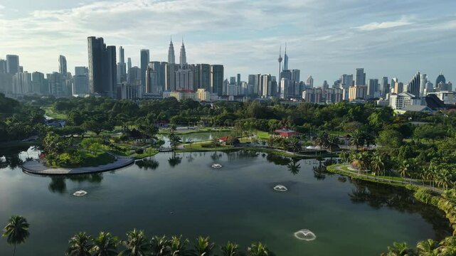 aerial view of kuala lumpur in the background with beautiful morning lark park scenery people jog