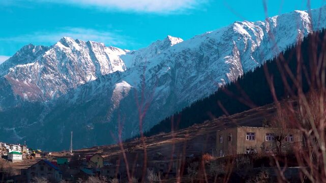 Snowy Himalayan mountain range during the winter season as seen from Triloknath village in Lahaul and Spiti district, Himachal Pradesh, India. Snowy Himalayas in winter. Natural background.