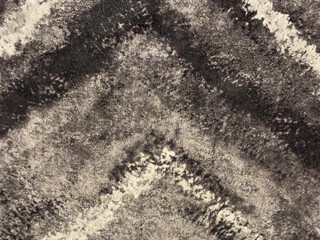 Close up of black and white monochrome grainy fabric with chevron pattern. Seamless background texture.