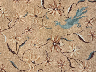Floral vintage carpet with flowers, branch, bird, and twigs. Classic vintage carpet rug with floral ornaments and swirls pattern. Seamless background texture.