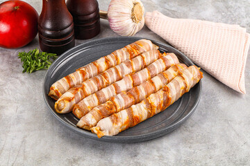 Raw sausages wrapped in bacon