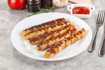 Grilled meat sausages wrapped bacon