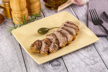 Roasted duck breast slices in the plate