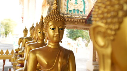 Golden Buddha Statues in Serene Buddhist Temple Setting