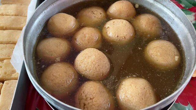 Nolen gur Rosogolla served in a vessel in a Bengali wedding