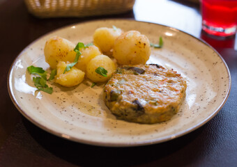 Chicken cutlet with vegetables with boiled potatoes on a plate