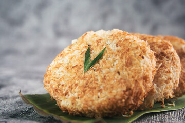 Indonesian Traditional Coconut Cake called Sagon on Banana Leaf with Rustic Background Setting