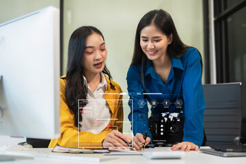 Two young Asian businesswoman discuss project manager working and update tasks and chart scheduling.