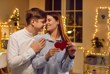 Happy couple embraces and kisses on Valentine Day, celebrating romance. Love and affection are evident during this special holiday, bringing joy and togetherness as they enjoy the day of lovers.