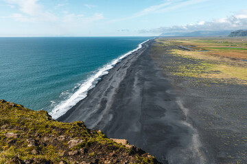 Gorgeous landscape with unique basalt arch on Dyrholaey Endless Beach Nature Reserve on Atlantic South Coast