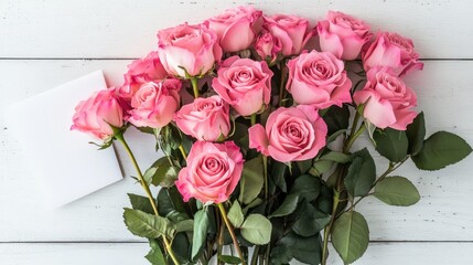 Greeting card mockup with a pink rose bouquet and a matching envelope, styled elegantly on a clean white wooden surface.