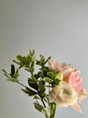 Bouquet with cream ranunculus, pink amaryllis and pittosporum