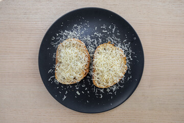 Bread topped with grated cheese.