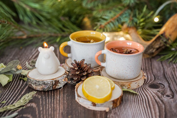 Cozy winter vibes with herbal tea, dried citrus slices, and seasonal decor – Christmas lights and fir tree branches