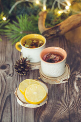 Cozy winter vibes with herbal tea, dried citrus slices, and seasonal decor – Christmas lights and fir tree branches