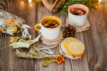 Cozy winter vibes with herbal tea, dried citrus slices, and seasonal decor – Christmas lights and fir tree branches