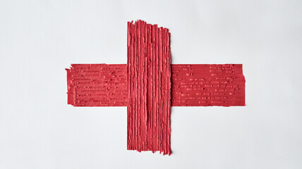 Obraz premium Rectangular Vibrant Red Tape with Textured Surface Resembling Fabric or Wall, Placed Against a White Background, Highlighting Bold Color and Contrast in a Minimalist Composition