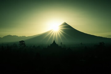 Sunrise Over Majestic Mountain with Silhouette of Ancient Temple Amidst Misty Landscape, Capturing the Serenity of Nature and Spiritual Harmony