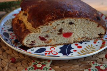 Christollen. Tradiotional sliced bread with candied fruits made for Christmas on a plate on wooden...