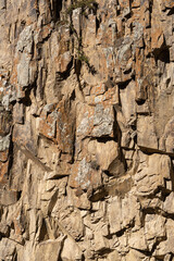 Chegem Gorge. Kabardino-Balkaria. El-Tyubu. Steep cliffs consist of rocks with multi-colored vertical texture. Natural design concept.