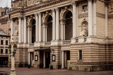 A large building with a statue of a woman on the front