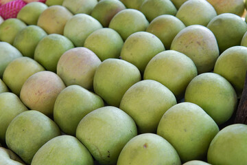 Fresh green apples are displayed in a fruit shop. This photo is ideal for use in poster designs, greeting cards, or as an illustration for articles about fruits.