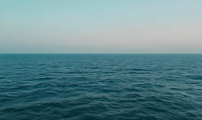 Obraz premium A serene view of calm ocean waters under a soft sky, evoking tranquility and peace.