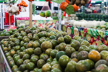 Green sweet oranges in a fruit shop are suitable for use in poster designs, or as illustrations for articles about fruits.