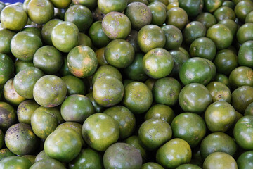 Green sweet oranges in a fruit shop are suitable for use in poster designs, or as illustrations for articles about fruits.