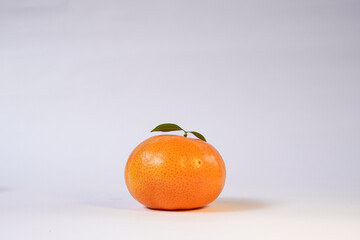 Tangerine or Mandarin orange on a white background is suitable for use in poster designs, or as an illustration for articles about fruits.