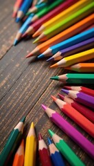 Fototapeta premium Background of vibrant multicolored pencils scattered on a wooden table, art supplies, pencil box, colorful stationery
