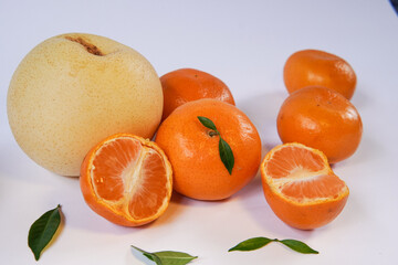 The concept of Tangerine or Mandarin orange with Grapes and Pears on a white background is suitable for design needs, as an illustration for articles about fruits and others.