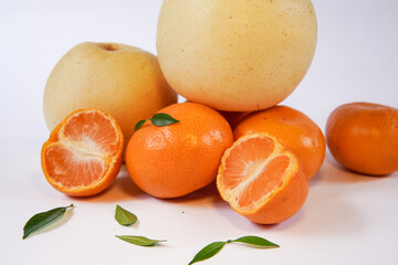 The concept of Tangerine or Mandarin orange with Grapes and Pears on a white background is suitable for design needs, as an illustration for articles about fruits and others.