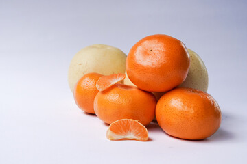 The concept of Tangerine or Mandarin orange with Grapes and Pears on a white background is suitable for design needs, as an illustration for articles about fruits and others.